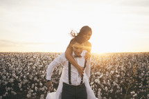 a bride and groom in a field of cotton 