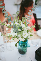 flowers in a vase on a set table 