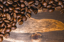 Coffee beans on a wooden background. Decorative banner for coffee products.