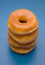 stacked donuts on a blue background 