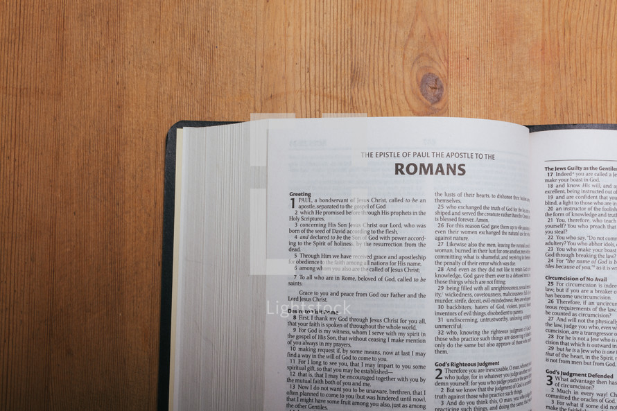 Romans on the pages of an open Bible 