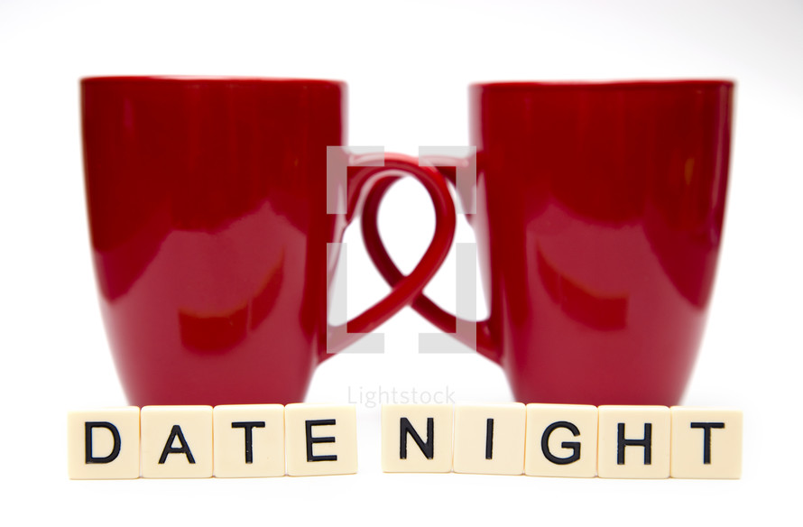 words date night and two red coffee mugs 