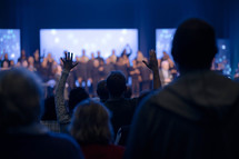 raised hands in the audience at a worship service 