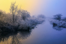 Beautiful winter sunrise and fog on river