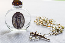 rosary beads and Magnificent Mary medal 