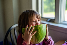 a girl eating watermelon 