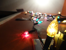 Low angle view of large Christmas lights displayed on wall with focus on yellow bulb near bottom of wall