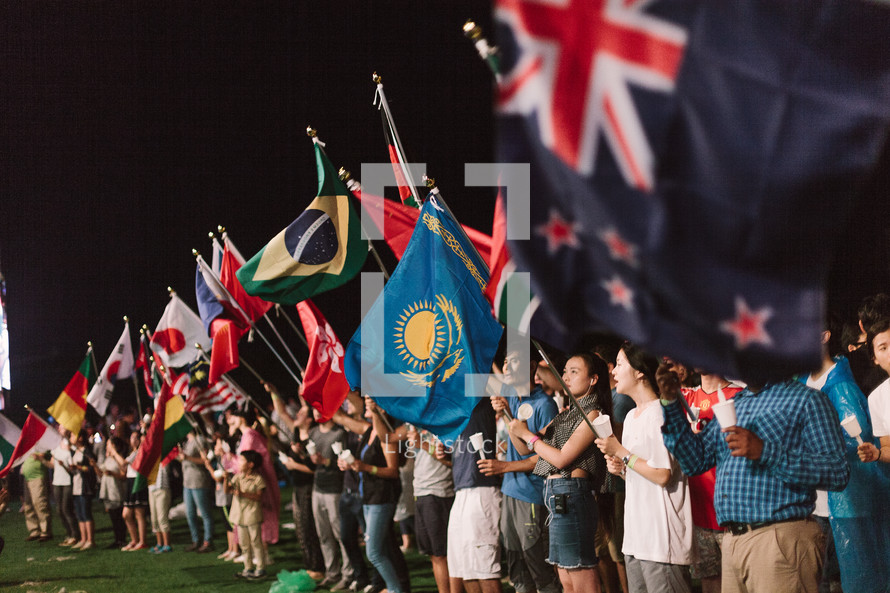 crowd waving flags of various nations 