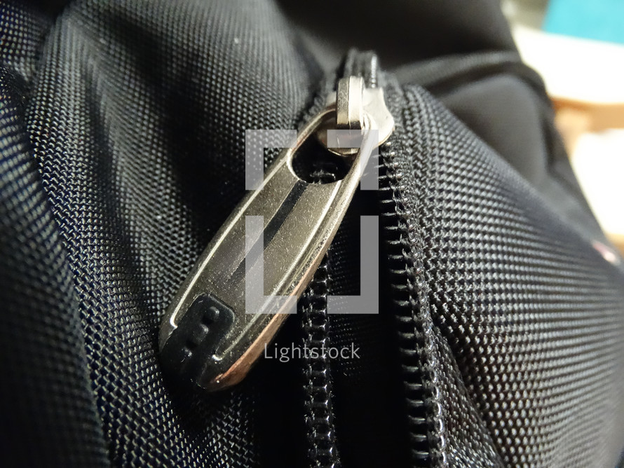 Close up of silver zipper on black bookbag