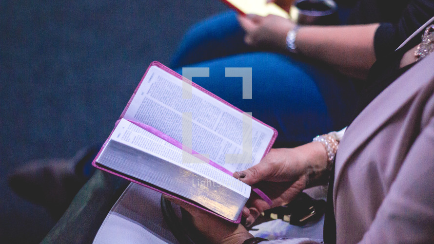 couple reading Bibles together in a church setting 