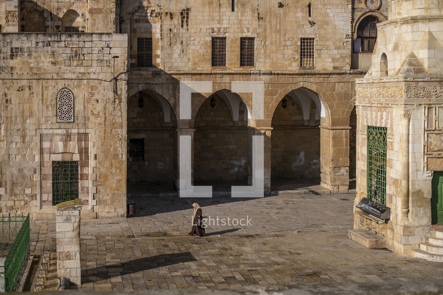 a woman in a courtyard in Jerusalem 