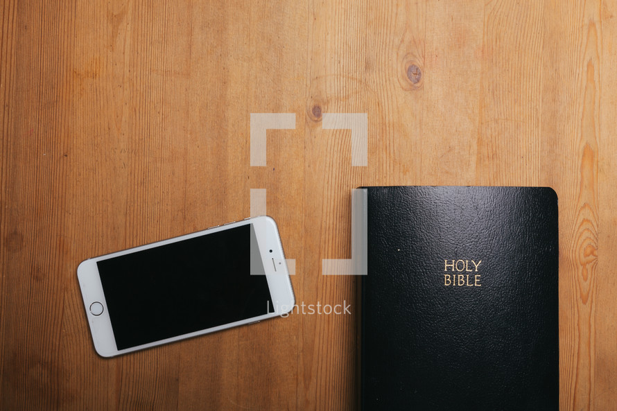 iphone and Bible on a table 