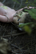 old doll in the dirt 