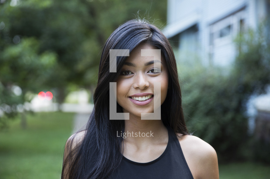 headshot of a young woman standing outdoors 
