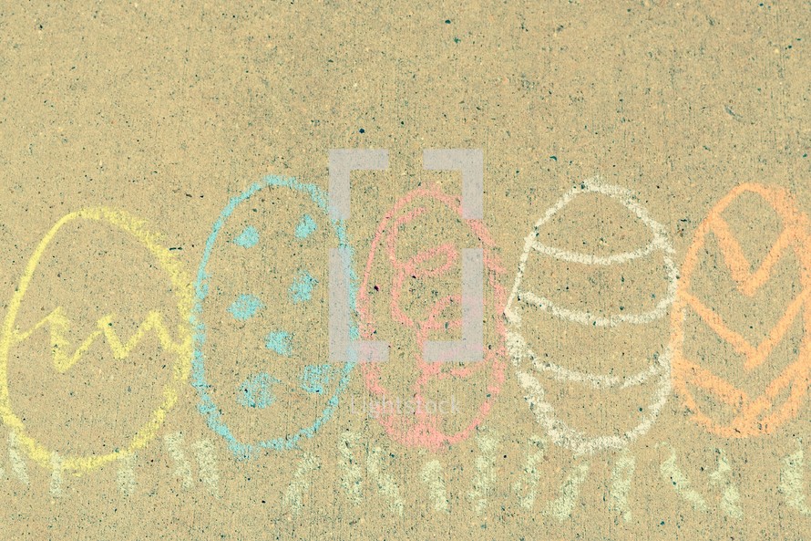 Easter eggs in grass border in sidewalk chalk 
