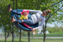 mother and daughter on a swing 