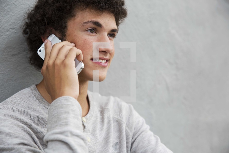 teen boy talking on a cellphone 