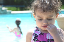 a toddler girl in a swim suit 