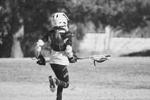 player on a Lacrosse team running onto the field 