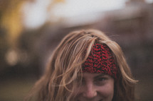 A woman wearing a headband and smiling