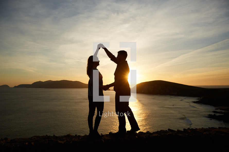 a couple dancing at sunset 