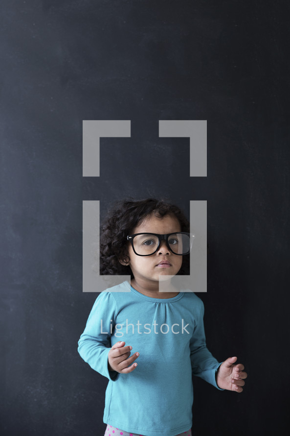 toddler girl wearing reading glasses 