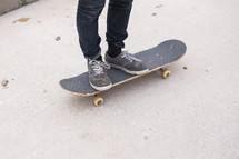 a man standing on a skateboard 