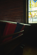 hymnals in church pews 