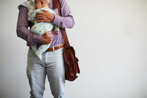 a working dad holding a baby 