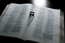 a wedding band between the  pages of a Bible 