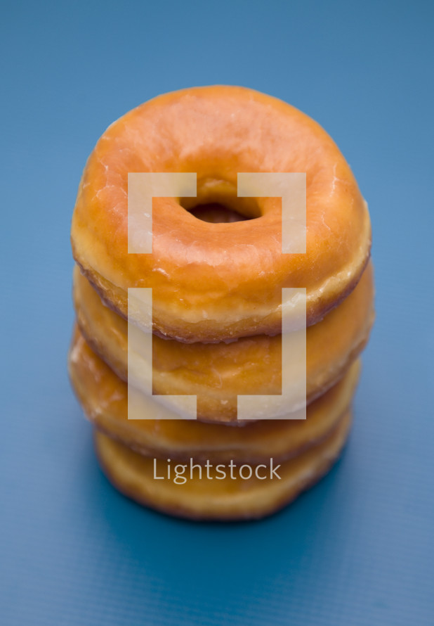 stacked donuts on a blue background 