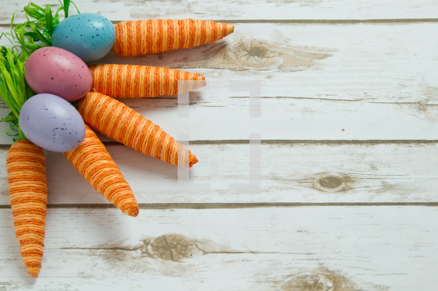 Easter eggs and carrots decorations on wood 