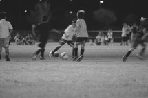 boys kicking a soccer ball during a game 