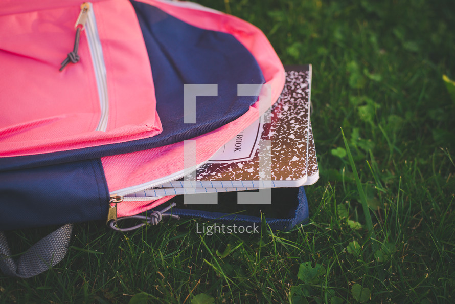 composition notebook in the grass