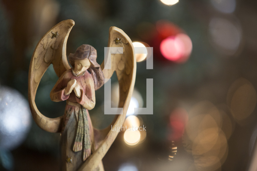 A Christmas background with a wooden angel figurine.