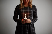 a woman holding a candle 