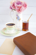 tea, muffins, and Bible on a table 