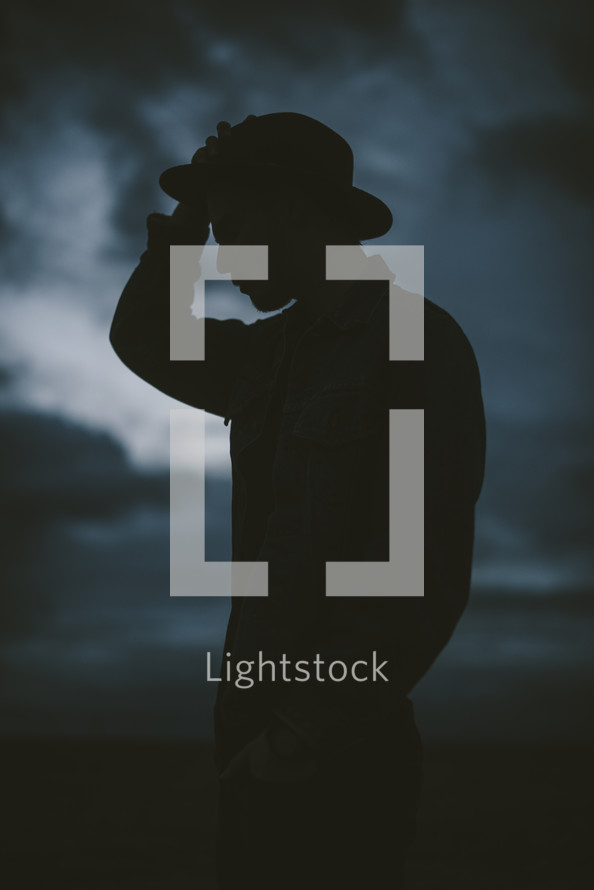 silhouette of a man in a hat 