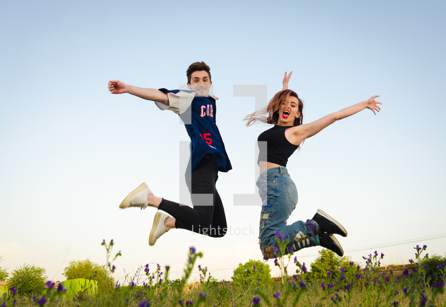 young couple jumping up 