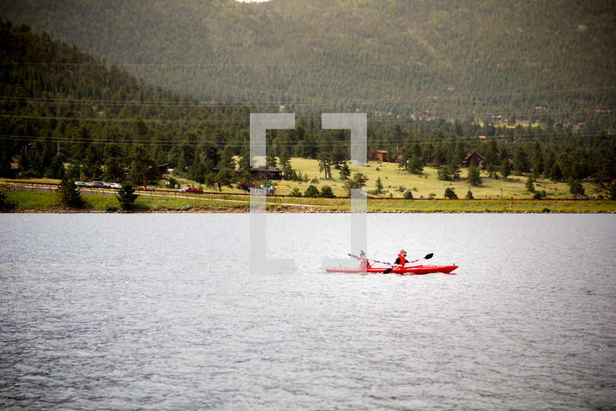 paddling in kayaks on a lake in summer 