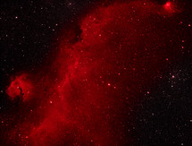 A dramatic bright red nebula in deep space