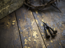 crown of thorns, three nails on a wood background 