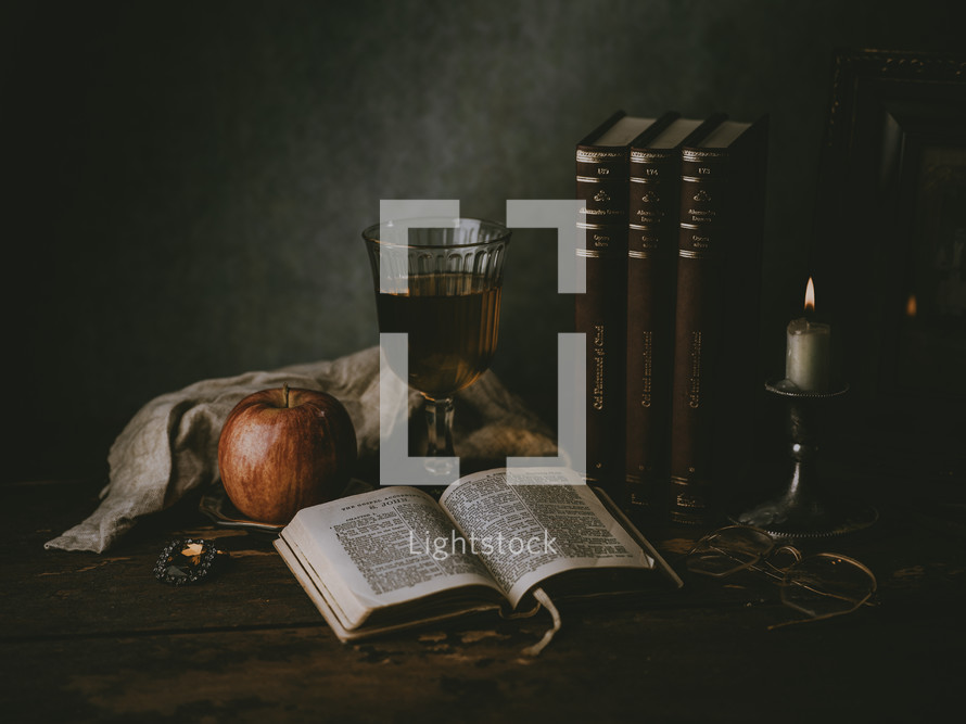 apple, chalice, and open Bible 