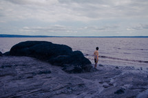 boy standing on a shore 