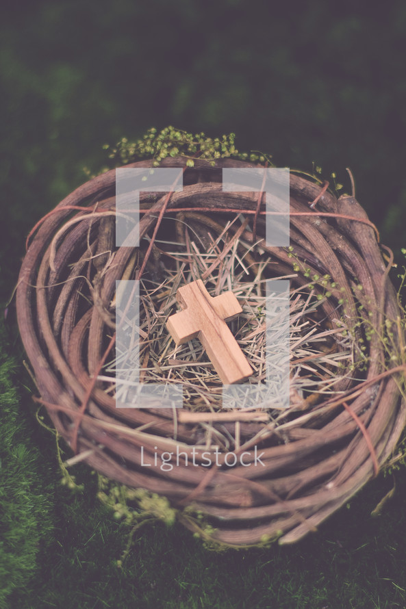 A wooden cross in a bird's nest
