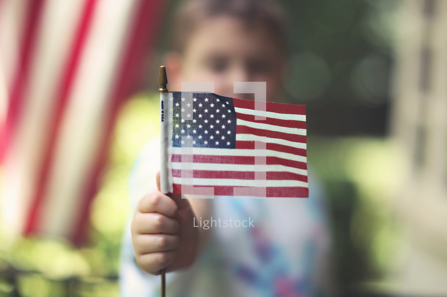 toddler boy holding an American flag 