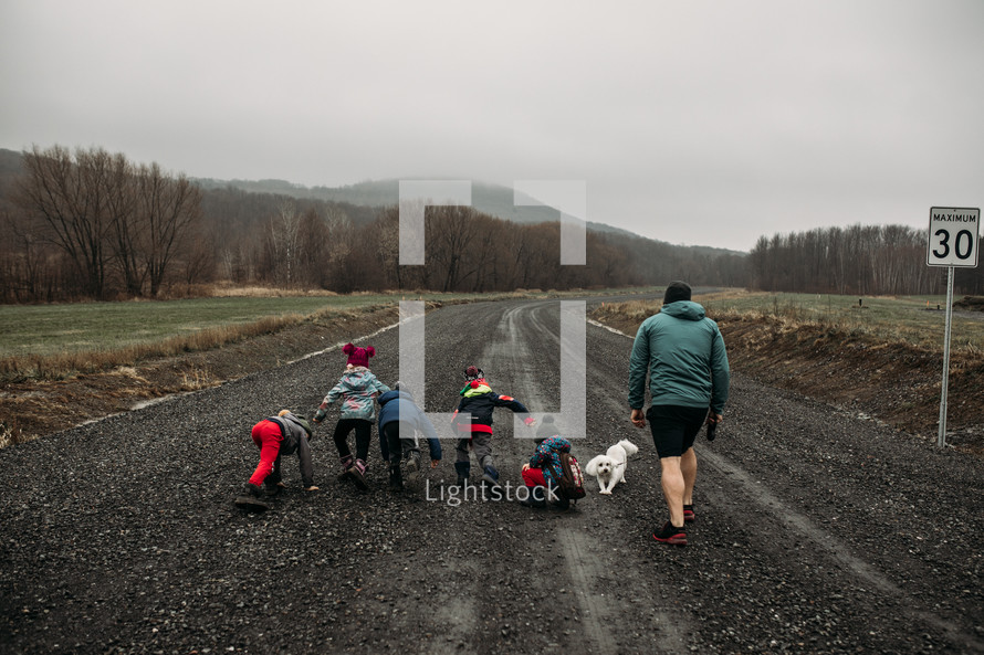 kids running on a gravel road 