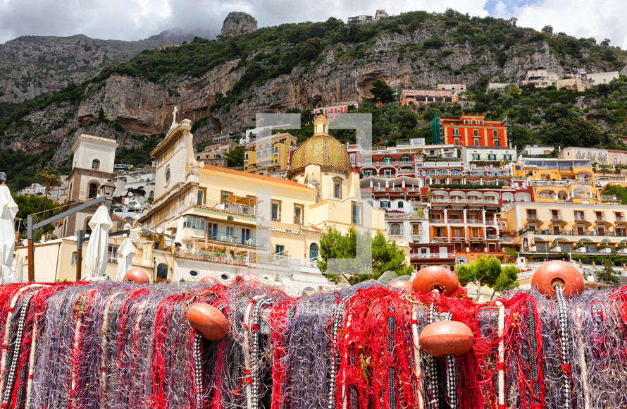 Fishing nets on the beach of Positano, Italy and view of church dome
