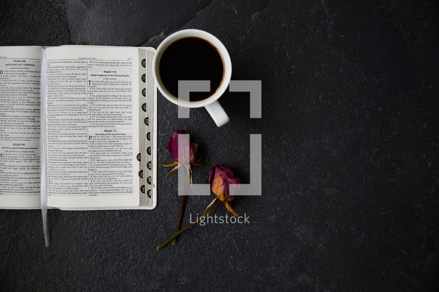 open Bible, dried roses, and coffee cup 