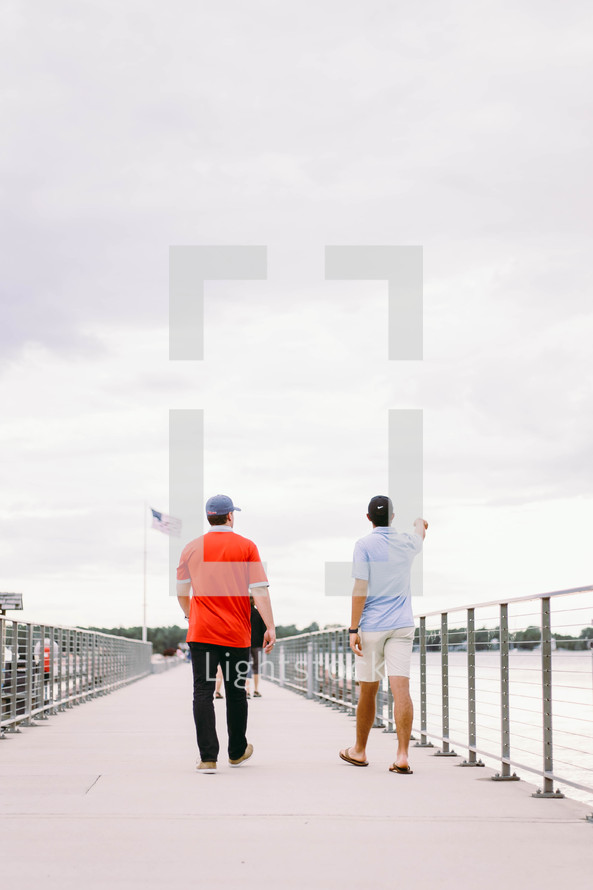 men walking on a pier 